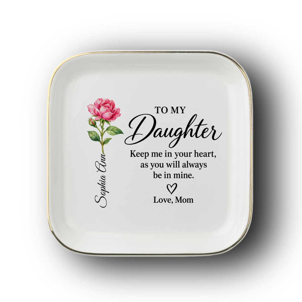 A square white ceramic dish with rounded corners, featuring a gold rim and a printed message for a daughter. The design includes a red birth flower on the left and the personalized name and signature line.